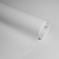 Studio photograph of the white geometric wallpaper roll highlighting the deep relief of the luxury textured vinyl.